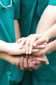 Medical team joining hands together