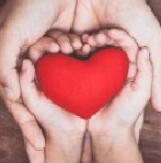 Hands cradling a red heart