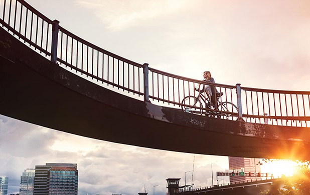 Cyclist on a bridge at sunset